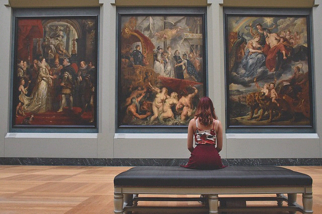 Art gallery Girl sat on bench in art gallery