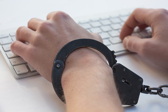 Hackers arrested Handcuffs on keyboard