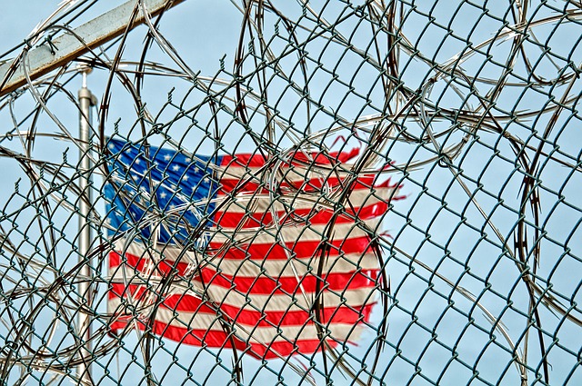 American flag and prison fence