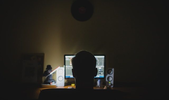 16 year old hacker makes $460000 hacker sat at computer screen